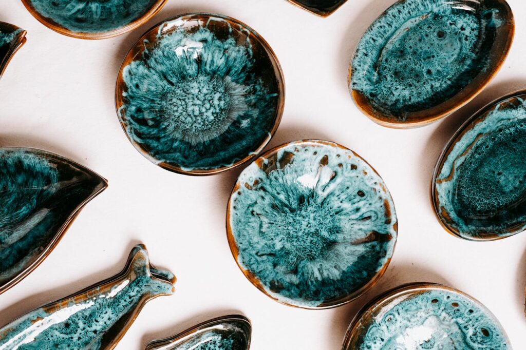 An artistic collection of handcrafted turquoise pottery bowls and plates.