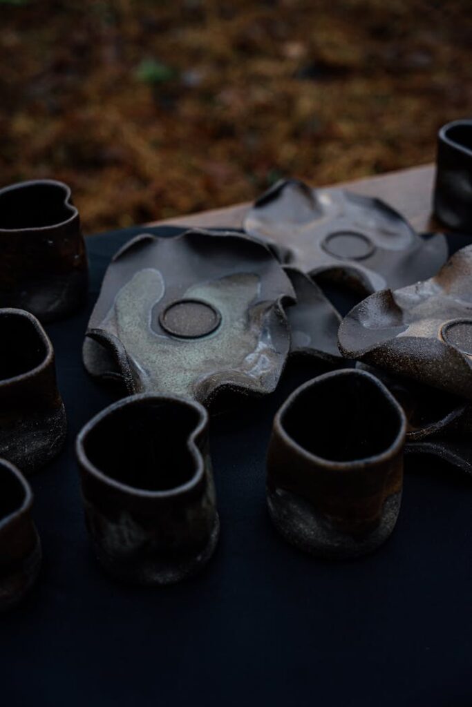 Artistic display of handmade ceramics with unique organic shapes.